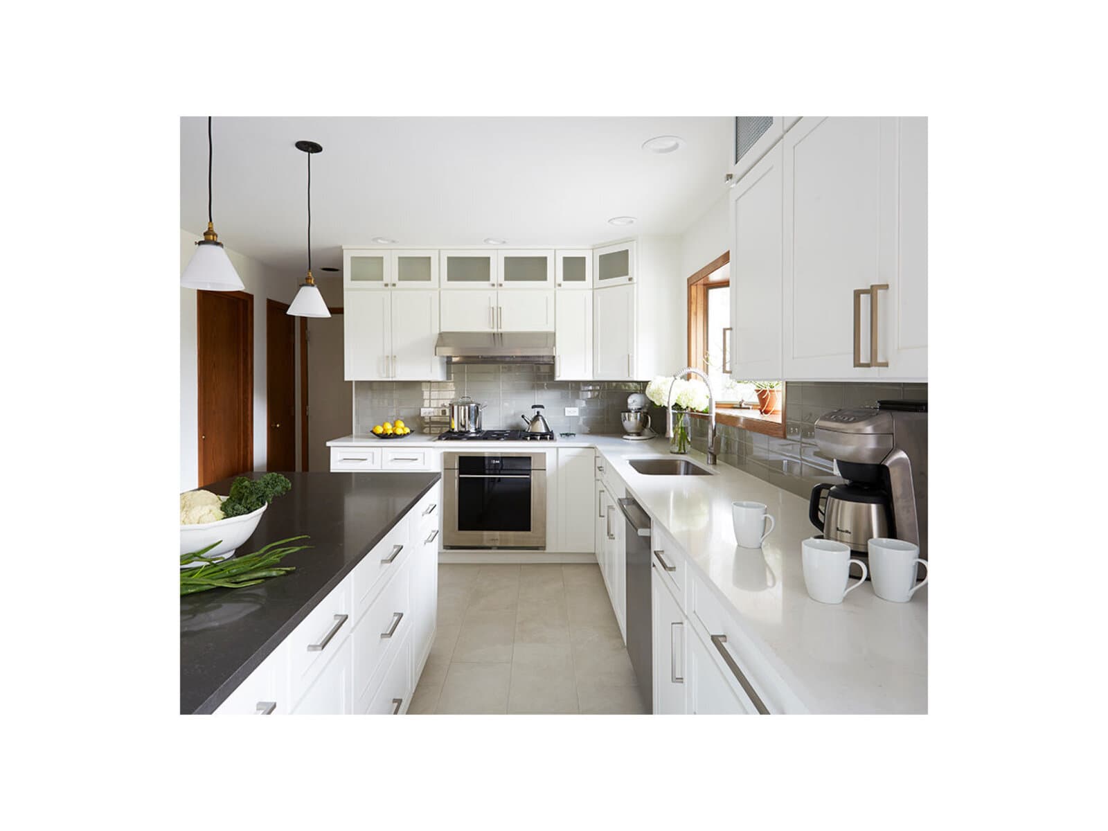 Inset kitchen cabinetry in a chalk white finish with a range alcove